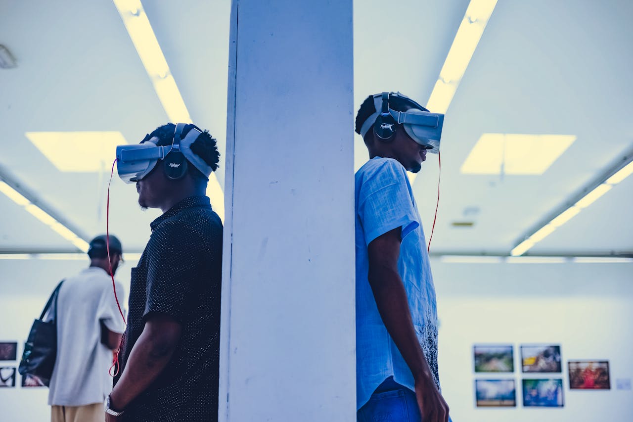 Two men using VR headsets in a modern indoor gallery setting.
